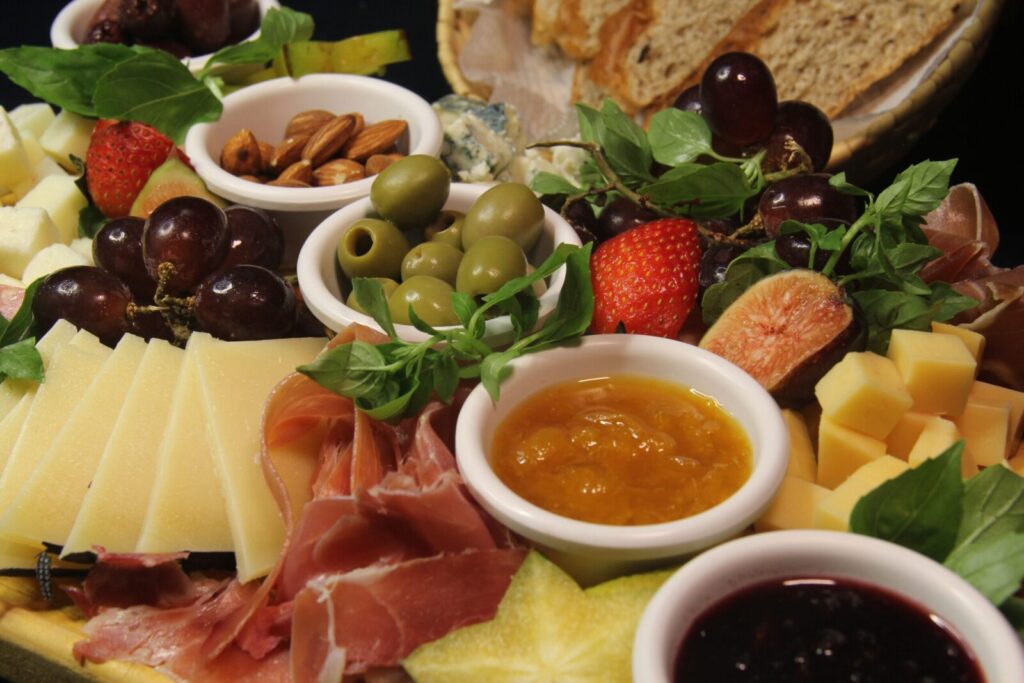 Explore a vibrant charcuterie board featuring cheeses, olives, fruits, and meats, perfect for gourmet dining.
