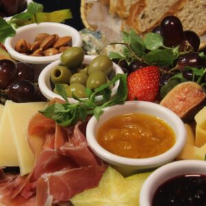 Explore a vibrant charcuterie board featuring cheeses, olives, fruits, and meats, perfect for gourmet dining.
